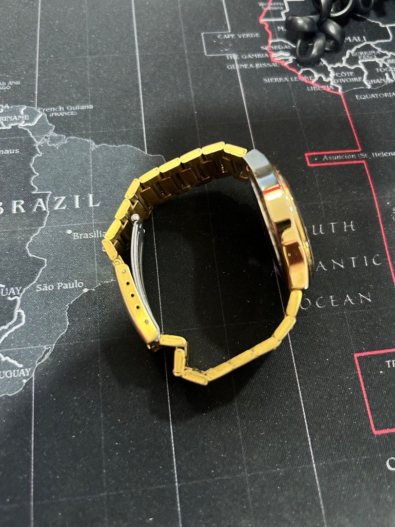 Gold-tone Link Watch (Category: Women's Watches) located in Caloocan City. Submitted by lagretta (Listing ID 1465400176, Image 2). Description: - Color/Finish: Gold-tone with metal link bracelet - Closure: Push-button clasp - Case Shape: Round - Condition: Worn with visible scuffs on gold plating - Crystal: Clean and clear surface - Battery: Status unknown.