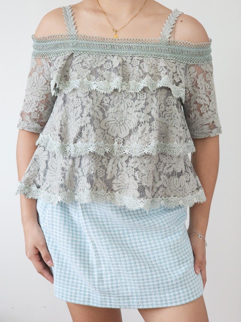 grey lace tiered ruffled cold shoulder top (Category: Sleeveless) located in Batangas. Submitted by curatedbylisilaloop (Listing ID 1465432171, Image 1). Description: AONE | grey lace tiered ruffled cold shoulder top Size: XS-S Bust: 36".