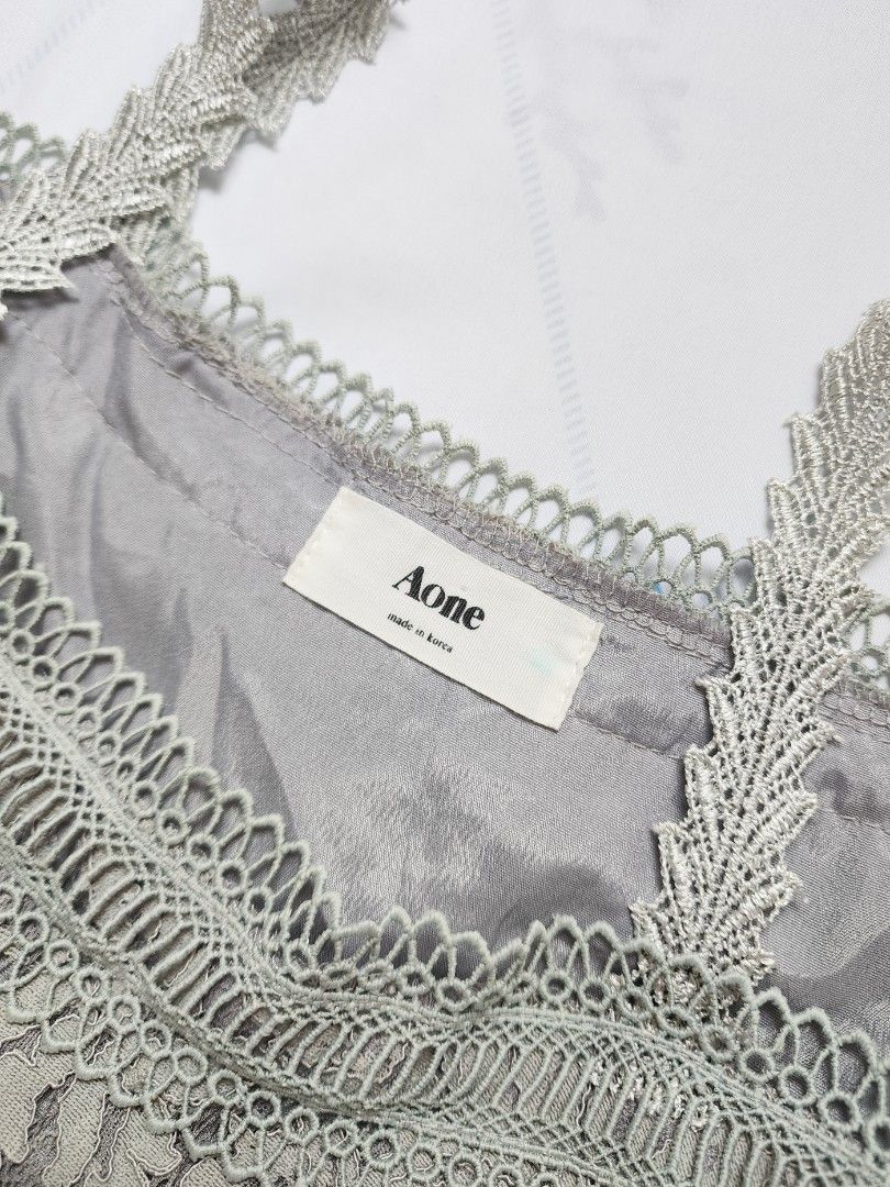 grey lace tiered ruffled cold shoulder top (Category: Sleeveless) located in Batangas. Submitted by curatedbylisilaloop (Listing ID 1465432171, Image 3). Description: AONE | grey lace tiered ruffled cold shoulder top Size: XS-S Bust: 36".