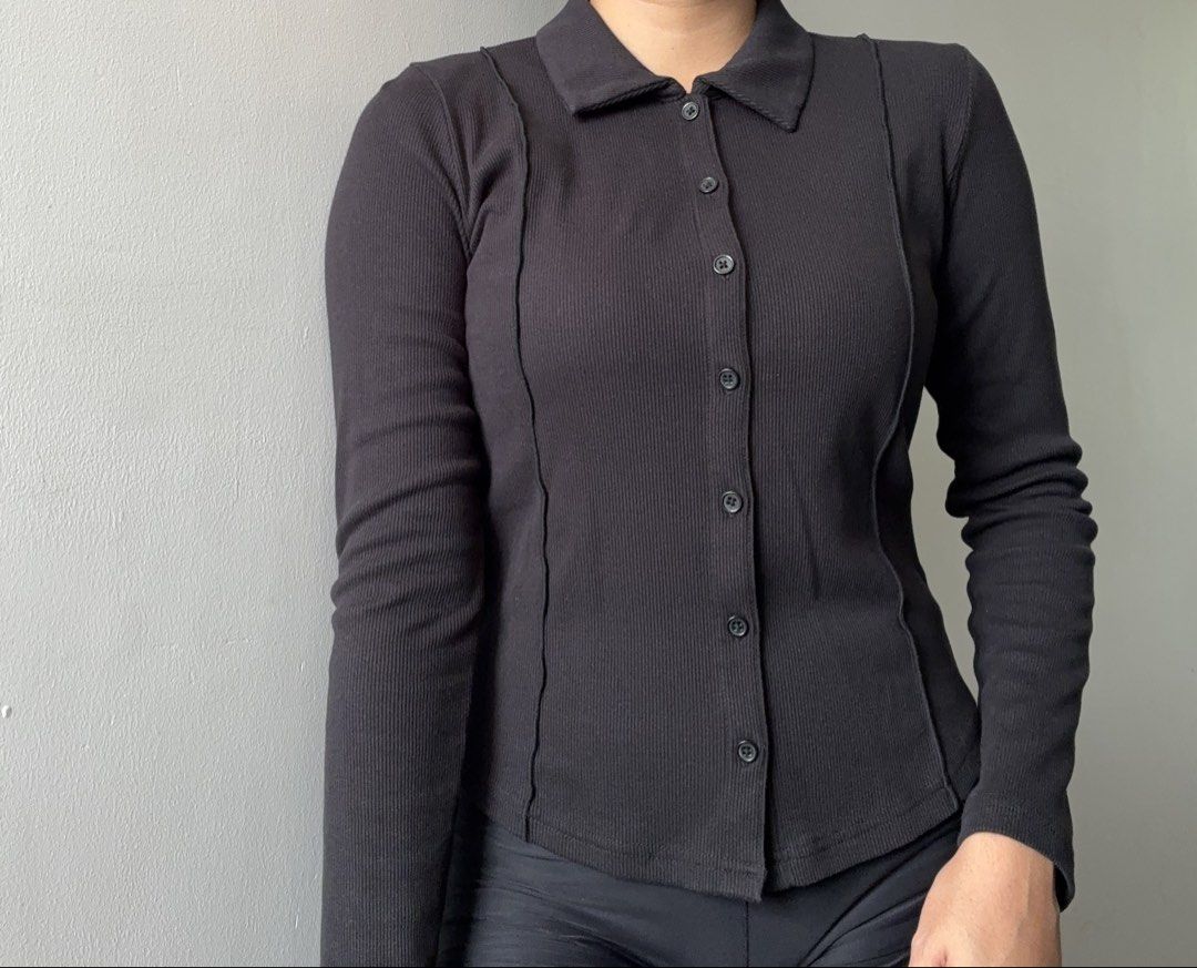 GU Black Ribbed Polo Cardigan (Category: Shirts) located in Dasmarinas. Submitted by fermosaclothing (Listing ID 1465414651, Image 2). Description: - Brand: GU - Size: S - Color: Black - Material: Stretchy cotton blend - Design: Ribbed texture, collar, front button closure, and unique front/sleeve seam details - Style: Versatile basic piece, great to pair with jeans or skirts for everyday wear.