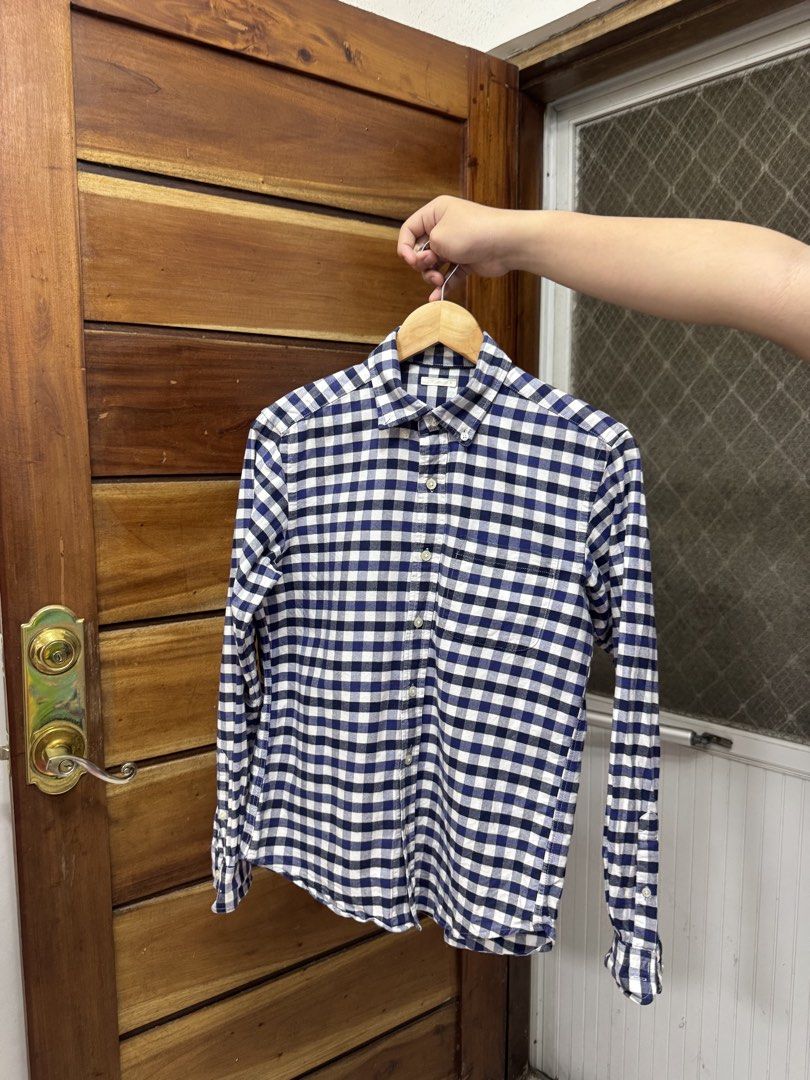 GU Navy and white checkered long sleeve button-down shirt (Category: Tshirts & Polo Shirts ) located in Cavite. Submitted by yakultjeni85475 (Listing ID 1465570268, Image 1). Description: - Color & Pattern: Navy and white checkered/plaid - Design: Long sleeve, front button closure, standard collar, and chest pocket - Condition: Well-maintained fabric with a clean overall look - Versatility: Great for daily wear, office settings, or weekend outing