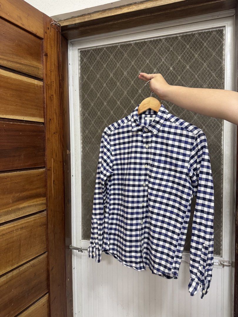 GU Navy and white checkered long sleeve button-down shirt (Category: Tshirts & Polo Shirts ) located in Cavite. Submitted by yakultjeni85475 (Listing ID 1465570268, Image 3). Description: - Color & Pattern: Navy and white checkered/plaid - Design: Long sleeve, front button closure, standard collar, and chest pocket - Condition: Well-maintained fabric with a clean overall look - Versatility: Great for daily wear, office settings, or weekend outing