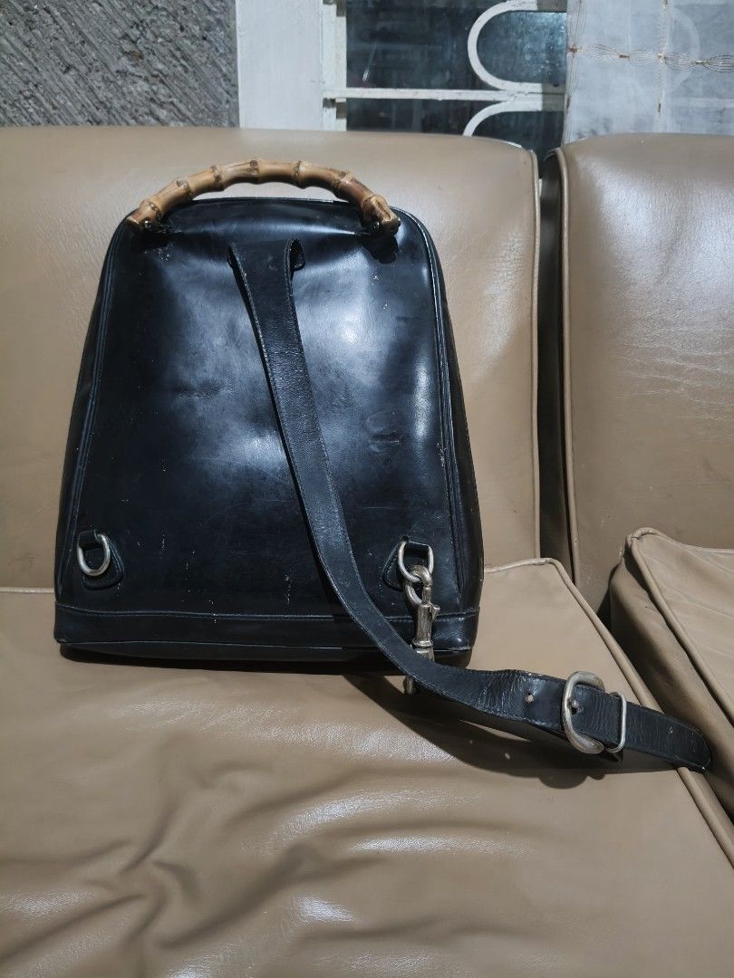 Gucci Black Bamboo Backpack (Category: Backpacks) located in Bulacan. Submitted by aichang21 (Listing ID 1465496848, Image 2). Description: - 100% Authentic Gucci backpack in black nylon and leather - Signature real bamboo top handle - Single adjustable leather strap with metal hardware - Front zip pocket and secure main compartment - Gucci monogram fabric interior lining with "Made In Italy" leather label - Features Gucci-embossed zipper pulls.