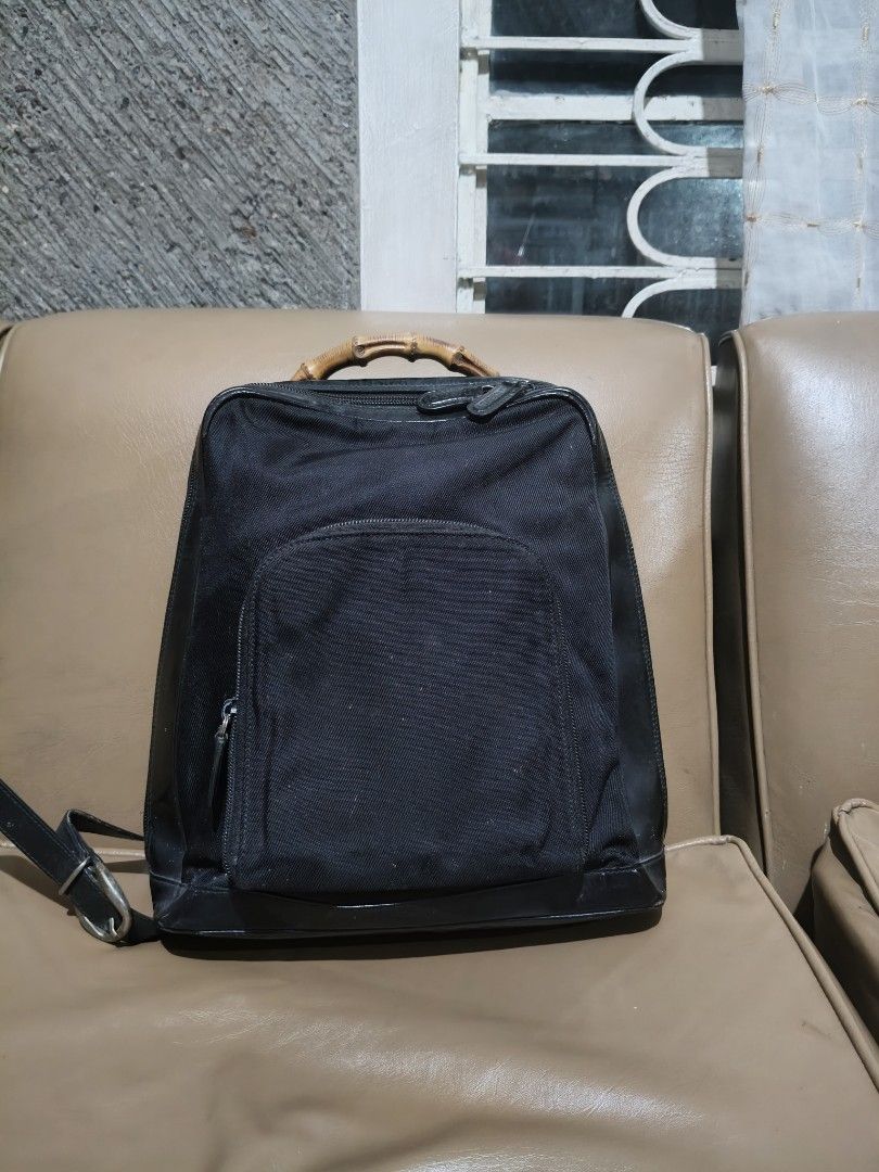 Gucci Black Bamboo Backpack (Category: Backpacks) located in Bulacan. Submitted by aichang21 (Listing ID 1465496848, Image 1). Description: - 100% Authentic Gucci backpack in black nylon and leather - Signature real bamboo top handle - Single adjustable leather strap with metal hardware - Front zip pocket and secure main compartment - Gucci monogram fabric interior lining with "Made In Italy" leather label - Features Gucci-embossed zipper pulls.
