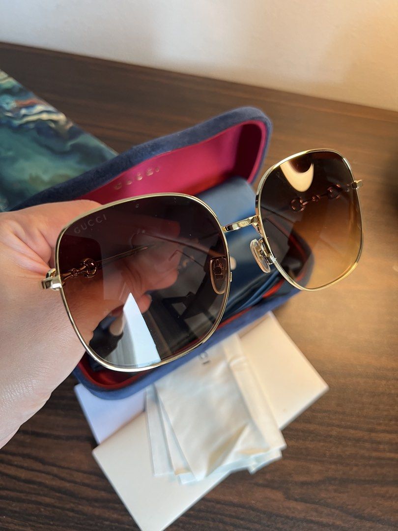 Gucci Horsebit Square Sunglasses Gold Brown Gradient (Category: Sunglasses & Eyewear) located in Makati City. Submitted by ciriacoria (Listing ID 1465445920, Image 2). Description: - Brand: Gucci Square Sunglasses - Color: Gold-tone metal with light beige acetate temple tips - Lenses: Brown gradient (clean, zero scratches) - Special Feature: Iconic horsebit detail along the temples - Inclusions: Original velvet hard case, satin pouch, and cleanin