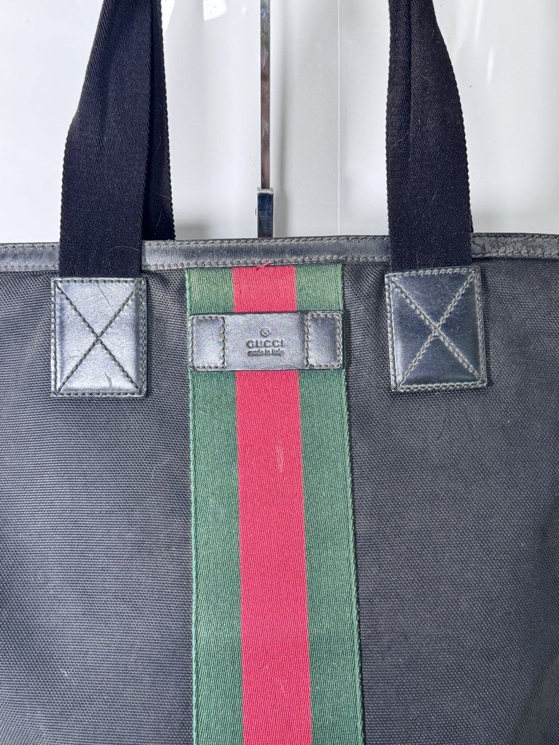 Gucci Web Stripe Black Canvas Tote Bag (Category: Tote Bags) located in Davao. Submitted by makeupbynoeh (Listing ID 1465506940, Image 2). Description: - ₱20,000.xx (negotiable) - Authentic Gucci Black Canvas Tote Bag - Iconic green and red web stripe down the center - Premium leather trim and dual fabric handles - Secure top zipper closure - Interior features standard lining, Gucci Made in Italy leather tag, and serial number (387107 204990) - I