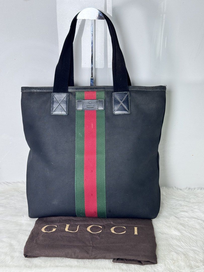 Gucci Web Stripe Black Canvas Tote Bag (Category: Tote Bags) located in Davao. Submitted by makeupbynoeh (Listing ID 1465506940, Image 1). Description: - ₱20,000.xx (negotiable) - Authentic Gucci Black Canvas Tote Bag - Iconic green and red web stripe down the center - Premium leather trim and dual fabric handles - Secure top zipper closure - Interior features standard lining, Gucci Made in Italy leather tag, and serial number (387107 204990) - I