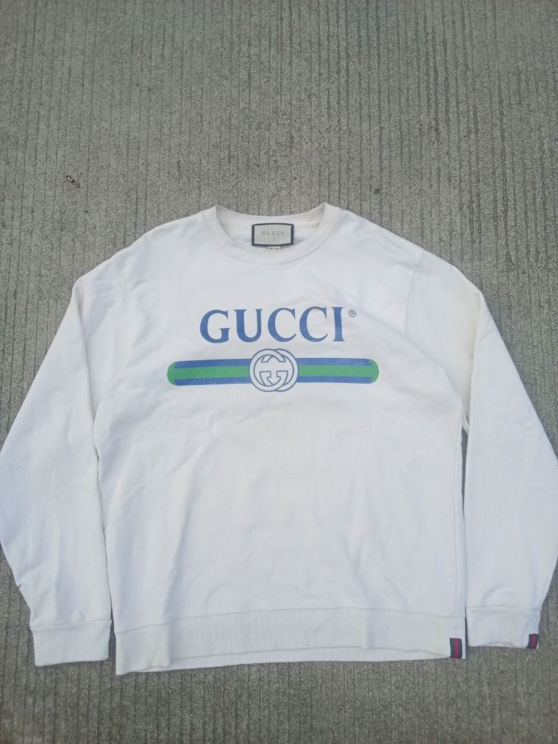 Gucci White Logo Sweatshirt (Category: Coats, Jackets and Outerwear) located in Caloocan City. Submitted by mysticdog-6a6b (Listing ID 1465447398, Image 1). Description: - Authentic Gucci sweatshirt in classic white - Features iconic blue/green logo graphic with Interlocking G emblem - Size: Medium (M) - Material: Comfortable cotton blend fleece - Details: Ribbed collar, cuffs, and hem - Origin: Made in Italy - Condition: Excellent.