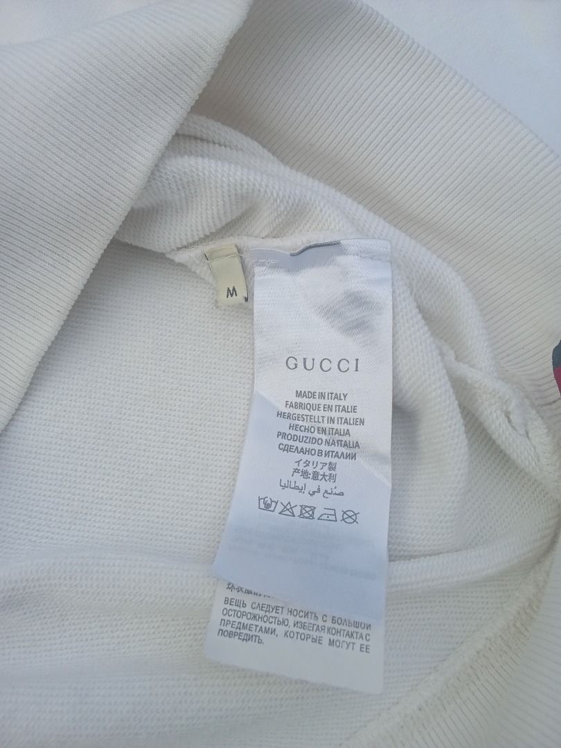 Gucci White Logo Sweatshirt (Category: Coats, Jackets and Outerwear) located in Caloocan City. Submitted by mysticdog-6a6b (Listing ID 1465447398, Image 3). Description: - Authentic Gucci sweatshirt in classic white - Features iconic blue/green logo graphic with Interlocking G emblem - Size: Medium (M) - Material: Comfortable cotton blend fleece - Details: Ribbed collar, cuffs, and hem - Origin: Made in Italy - Condition: Excellent.