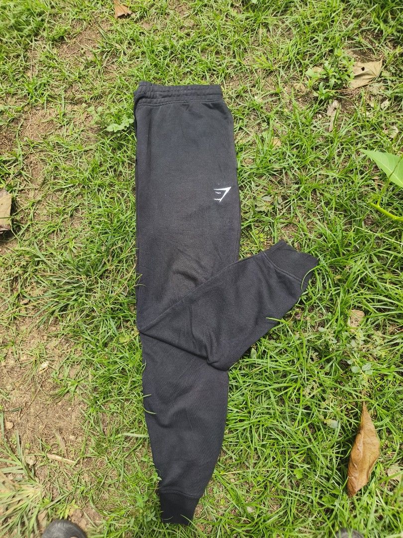 GYMSHARK Joggers (Category: Activewear) located in Manila. Submitted by carlorufo11372 (Listing ID 1465409026, Image 1). Description: Black Gymshark Crest Joggers featuring the brand's signature shark head logo on the upper left leg. Size 34 Lenght 40.
