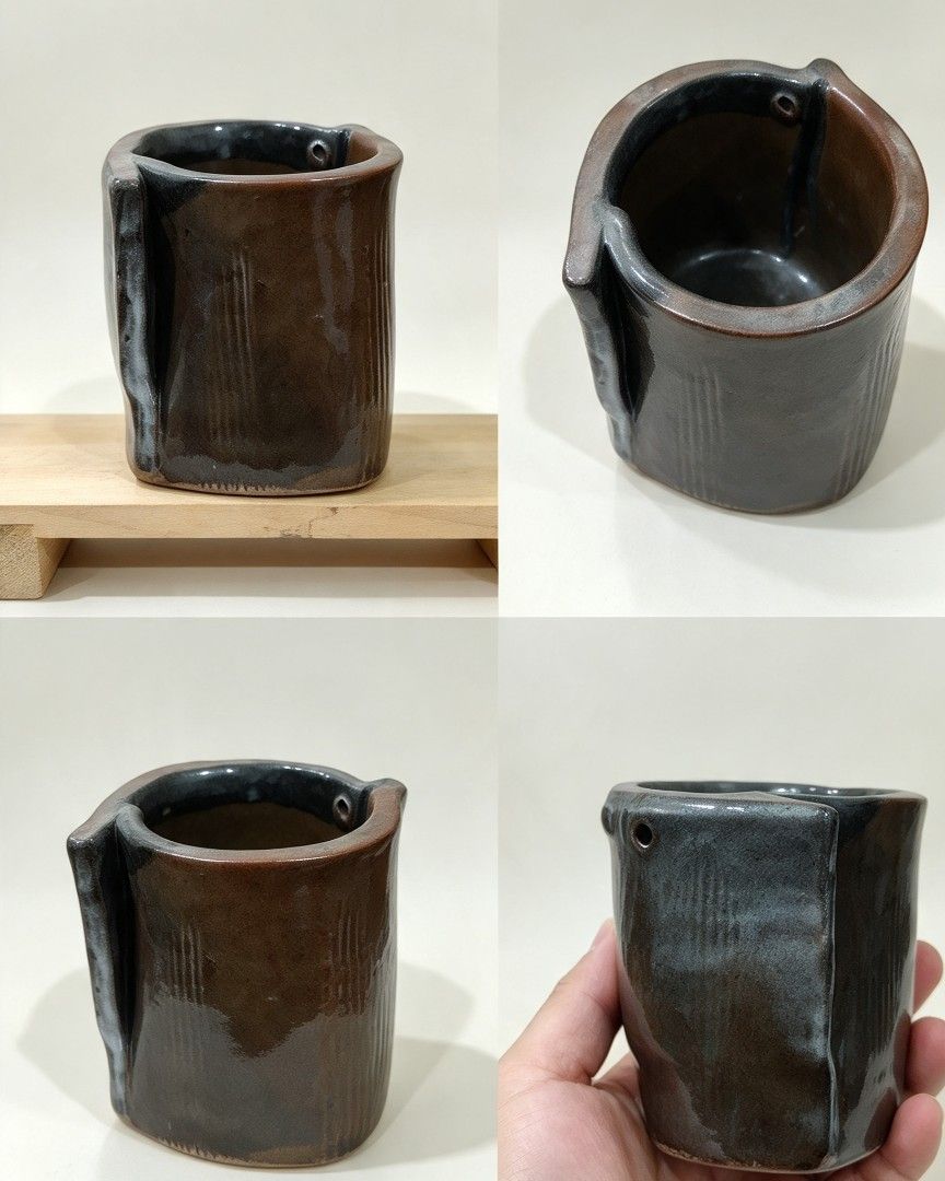 Handmade Ceramic Pot Planter with Unique Fold Design (Category: Pots & Planters) located in Baguio. Submitted by akileshomeprints (Listing ID 1465464548, Image 1). Description: Japan surplus- Handcrafted ceramic pot with unique rolled-over fold design - Features an earthy brown and dark grey glossy glaze finish - Beautiful texture lines pressed into the outer clay body - Includes a small drainage hole near the upper rim - Sturdy base for reliable