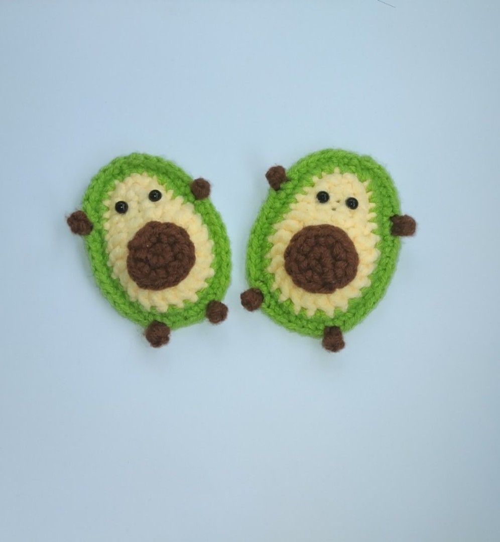 Handmade Crochet Avocado Pair Plushies (Category: Handmade Craft) located in Manila. Submitted by mightytiger.ba9f66 (Listing ID 1465397357, Image 1). Description: - Set of 2 handmade crochet avocado plushies - Features bright green edges, cream centers, and dark brown pits - Adorned with tiny brown hands, feet, and friendly black bead eyes - Soft and huggable yarn texture - Perfect as cute bag charms, keychains, or mini desk decorations - Brand 