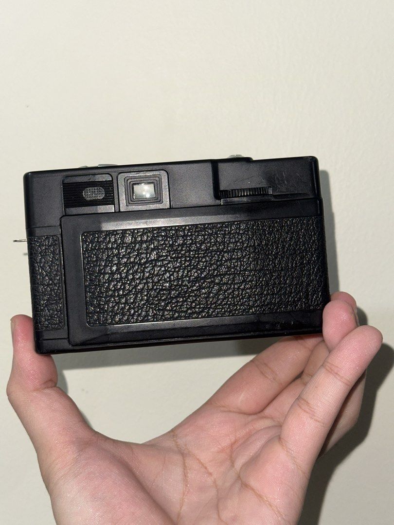 Hanimex 35se 35mm Film Camera (Category: Cameras) located in Quezon City. Submitted by jeps-sells (Listing ID 1465404512, Image 2). Description: - Model: Hanimex 35se Film Camera (Classic Black) - Lens: Hanimar 38mm f/5.6 fixed lens - Film Format: Uses standard 35mm film rolls - Flash: Built-in flash unit on the right side - Controls: Front-panel ASA selector switch with intuitive cloud and sun weather icons - Condition: Clean interior film chamb