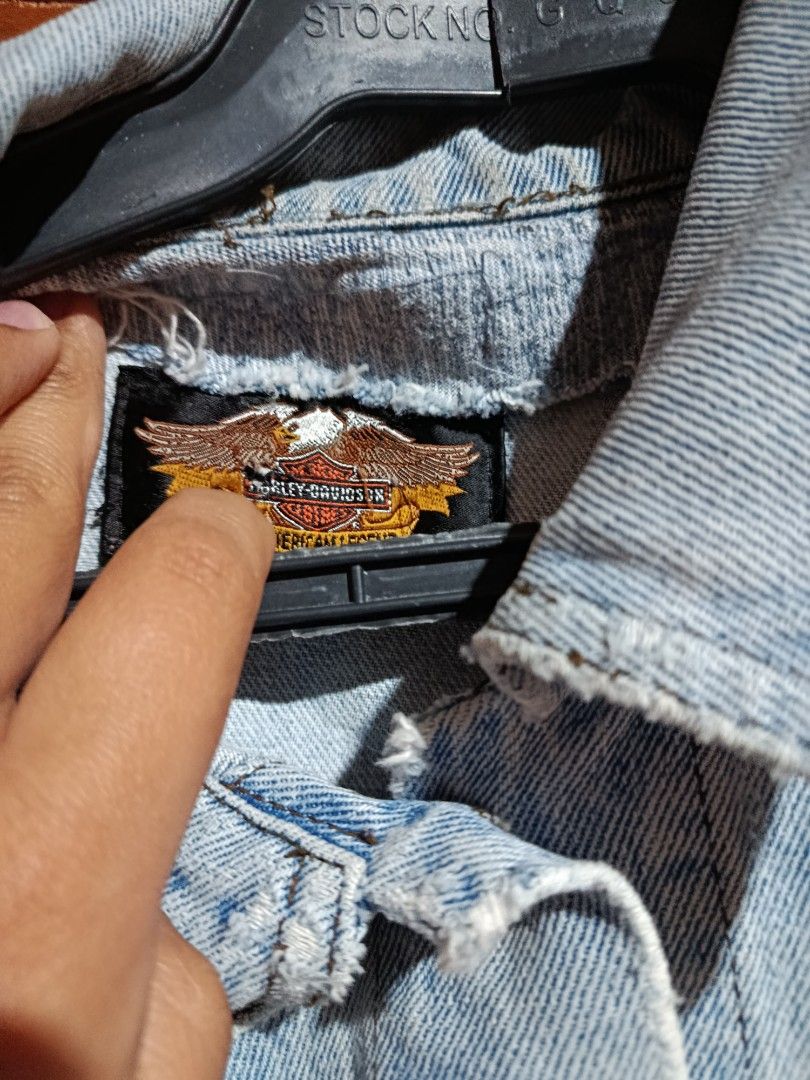 Harley-Davidson Light Wash Denim Vest (Category: Vests) located in Baguio. Submitted by dlv89288 (Listing ID 1465491573, Image 3). Description: - Brand: Harley-Davidson - Style: Classic biker denim vest, light wash with distressed edges - Closure: Button-down front with branded metal buttons - Pockets: Dual chest pockets with button flaps plus side pockets - Details: Embroidered Harley-Davidson patch on lower front and black brand tag above right