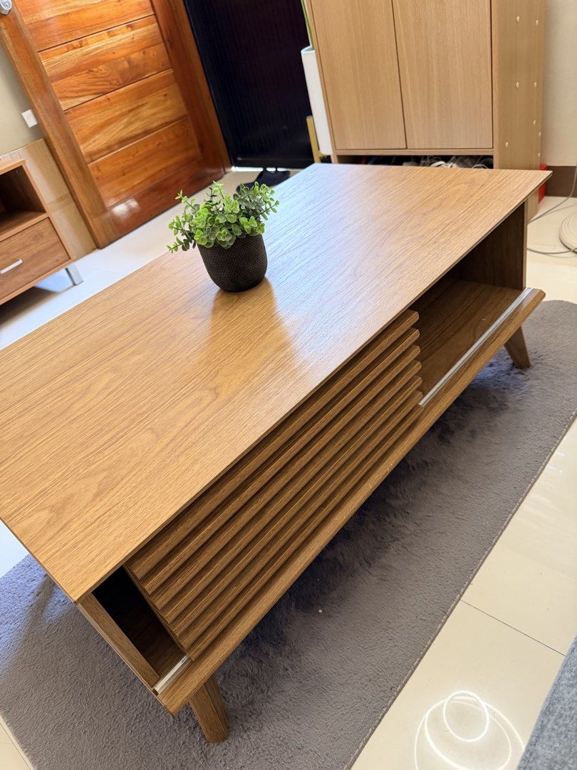 Haru Coffee Center Table (Category: Tables & Sets) located in Batangas. Submitted by belaluz09 (Listing ID 1465426719, Image 2). Description: - Model: Haru Coffee Center Table - Finish: Light oak - Design: Slatted sliding door with open storage shelf - Style: Mid-century modern with clean tapered wooden legs - Material: Sturdy particle board construction - Perfect for living rooms and daily use Please see all photos to appreciate slightly negotia