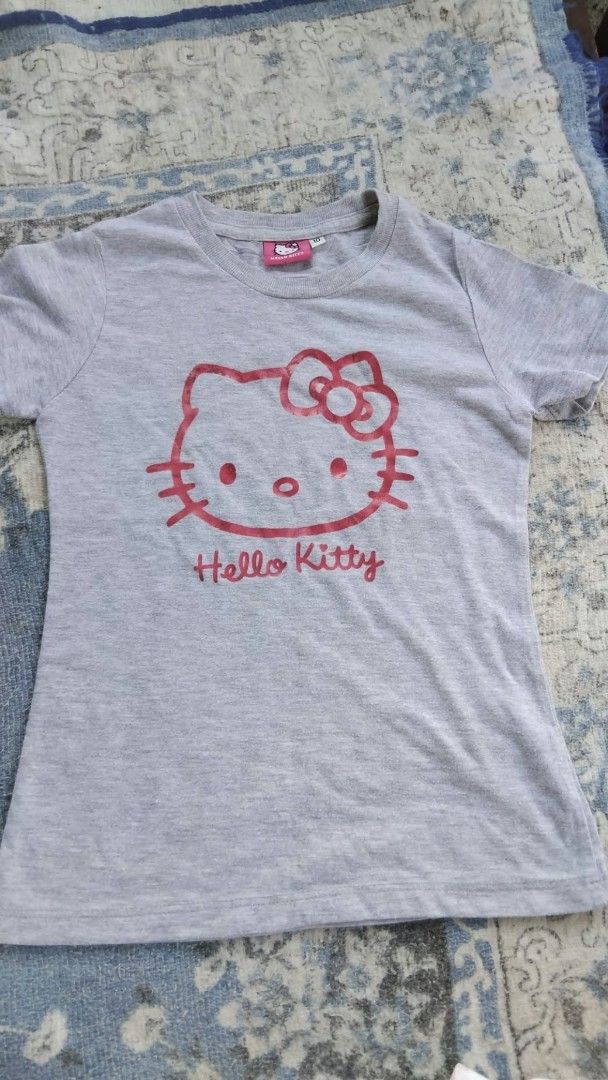 Hello Kitty Grey T-shirt Size 10 (Category: Shirts) located in Manila. Submitted by mightytiger.ba9f66 (Listing ID 1465393945, Image 1). Description: - Item: Grey Kitty Short-Sleeve T-Shirt - Size: 10 (Tag intact) - Material: Lightweight, breathable cotton - Design: Cute pink Kitty graphic and script logo - Style: Round neckline, casual everyday fit - Condition: Excellent / Well-maintained - Shipping: Fast ship-out from a trusted PH seller!.