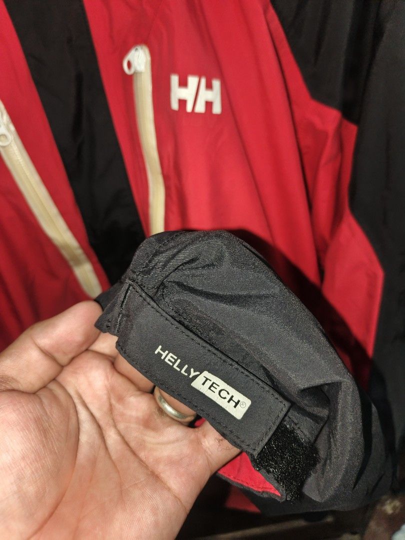 Helly Hansen Helly Tech Waterproof Hooded Jacket Red Black XL (Category: Coats, Jackets and Outerwear) located in Saravia. Submitted by foundandfavedbcd (Listing ID 1465533197, Image 2). Description: - Brand: Helly Hansen - Style: Waterproof hooded jacket - Colorway: Red and black - Size: XL - Technology: Helly Tech fabric - Features: Full zip front, dual chest zip pockets, adjustable drawstrings on hood, velcro adjustable cuffs, mesh inner linin