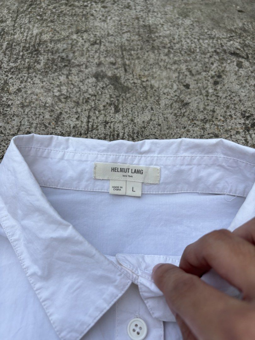 Helmut Lang White Long Sleeve Button Down Shirt Size L (Category: Longsleeves) located in San Pedro. Submitted by wharfthrift (Listing ID 1465444633, Image 2). Description: FOR SALE ‼️ Helmut Lang White Long Sleeve Button Down Shirt Size L GOOD CONDITION 9/10 ISSUE minimal stain check last photos (removable) SIZE 20 width 25 front length 27 back length 25 sleeves ₱3,000 + SF shipping via lalamove or j&t meet up around san pedro laguna or muntinlu