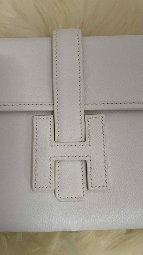 Hermes White Leather Clutch Bag (Category: Clutches) located in Makati City. Submitted by dgcurated09 (Listing ID 1465461219, Image 3). Description: - Brand: Hermes - Material: White textured leather - Hardware: Distinct 'H' clasp closure - Design: Flap over with structured sides - Size: Roughly 20 cm across - Inclusions: Original branded herringbone dust bag with drawstring - Condition: Excellent / Well-maintained - Perfect for date nights and s