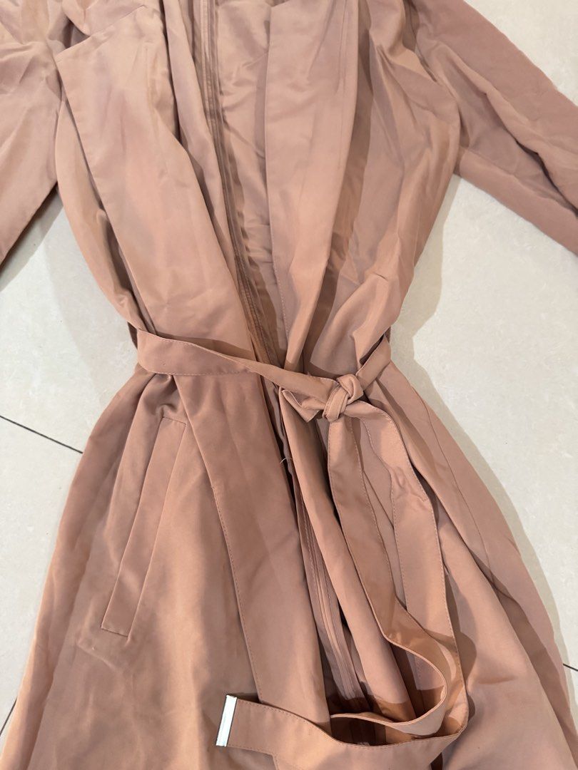 H&M Divided Brownish Pink Trench Coat (Category: Coats, Jackets and Outerwear) located in Quezon City. Submitted by sweetlyluxe (Listing ID 1465498060, Image 2). Description: - Brand: H&M Divided - Size: XS - Color: Pinkosh brown like terracotta - Material: Lightweight fabric, perfect for layering - Features: Open front with lapels, tied waist with matching belt, functional side pockets - Condition: Clean and ready to wear for work, office, trave