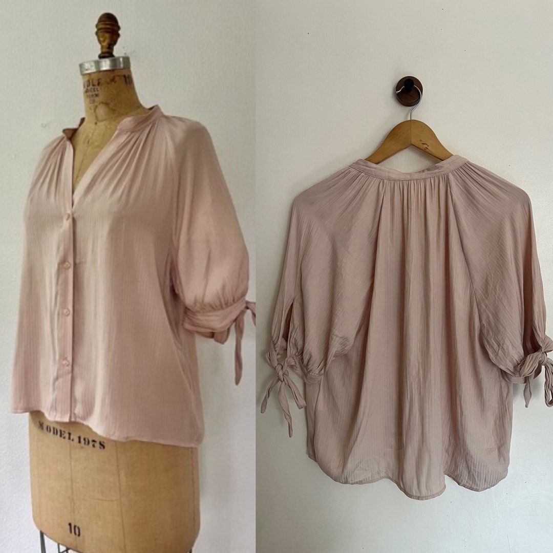 H&M Pink Button-Up Blouse Size US 6 (Category: Blouses) located in General Santos City (Dadiangas). Submitted by dresswithaly (Listing ID 1465412858, Image 2). Description: - Brand: H&M - Color: Soft pastel pink - Size: US 6 (Made in Indonesia) - Style: V-neck button-up with relaxed drape - Details: Gathered shoulder & back pleats, 3/4 sleeves with adjustable tie-bow cuffs - Material: Lightweight textured fabric - Condition: Excellent pre-loved /