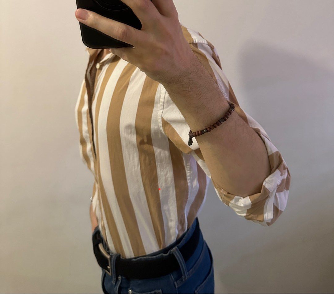 H&M Striped Regular Fit Button-Down Shirt Size M (Category: Tshirts & Polo Shirts ) located in Manila. Submitted by chris9837 (Listing ID 1465414121, Image 3). Description: - Brand: H&M - Style: Button-down shirt with classic collar and front closure - Fit: Regular fit - Pattern: Brown and white vertical stripes - Size: M (corresponds to 175/100A) - Condition: Clean fabric, tags intact Location: Parañaque. .