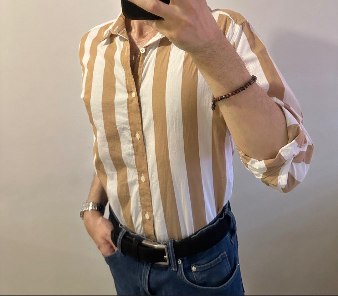 H&M Striped Regular Fit Button-Down Shirt Size M (Category: Tshirts & Polo Shirts ) located in Manila. Submitted by chris9837 (Listing ID 1465414121, Image 1). Description: - Brand: H&M - Style: Button-down shirt with classic collar and front closure - Fit: Regular fit - Pattern: Brown and white vertical stripes - Size: M (corresponds to 175/100A) - Condition: Clean fabric, tags intact Location: Parañaque. .