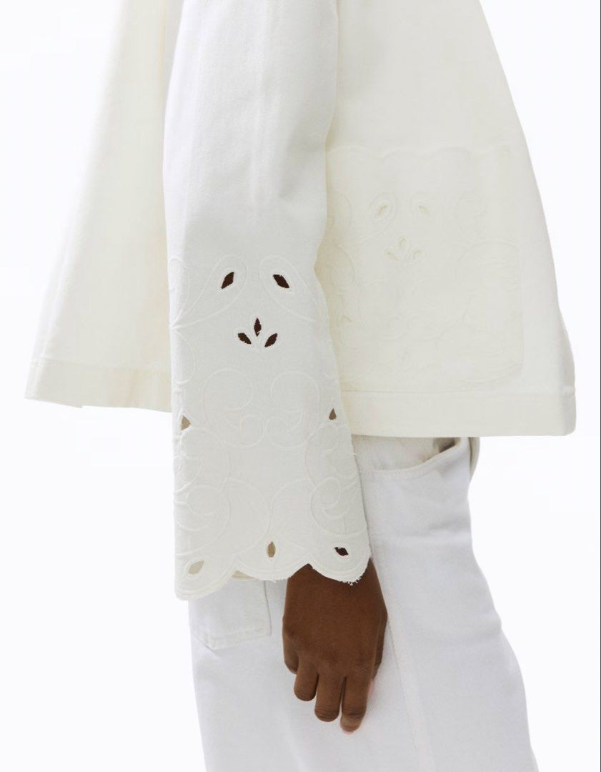 H&M White embroidered button up jacket (Category: Coats, Jackets and Outerwear) located in Paranaque City. Submitted by vestured.ph (Listing ID 1465540539, Image 3). Description: Washed only! Bought for 2,499 - Material: Comfortable white cotton-blend - Design: Cropped length with straight hem - Details: Horn-style front buttons - Accents: Scalloped embroidery on oversized collar, cuffs, and two patch pockets - Style: Great layering piece for coo