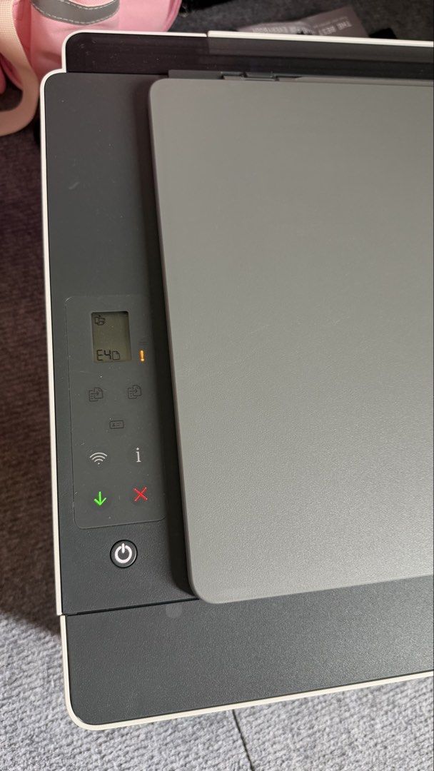 HP Smart Tank 580 All-in-One Printer (Category: Printers, Scanners & Copiers) located in Muntinlupa City. Submitted by nisantos (Listing ID 1465437073, Image 3). Description: HP Smart Tank 580 wireless all-in-one printer. Uses GT52 color and GT53XL black ink tanks visible on the front panel. Compact white and dark grey body design with built-in scanner lid on top. LCD screen shows an E40 error code and warning light currently active. Great tank s