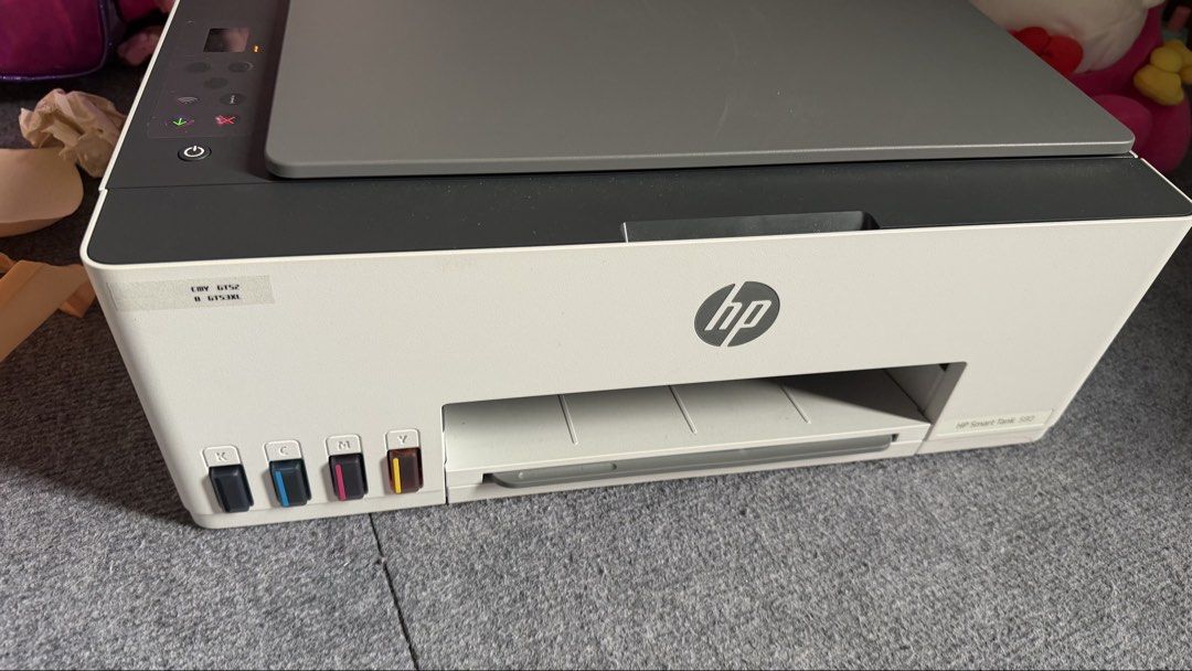 HP Smart Tank 580 All-in-One Printer (Category: Printers, Scanners & Copiers) located in Muntinlupa City. Submitted by nisantos (Listing ID 1465437073, Image 1). Description: HP Smart Tank 580 wireless all-in-one printer. Uses GT52 color and GT53XL black ink tanks visible on the front panel. Compact white and dark grey body design with built-in scanner lid on top. LCD screen shows an E40 error code and warning light currently active. Great tank s