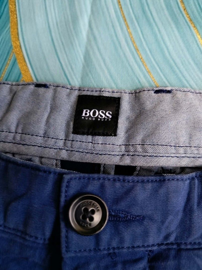 Hugo Boss Blue Slice-Short Size 30 (Category: Shorts) located in Manila. Submitted by virgiliosa38485 (Listing ID 1465500164, Image 2). Description: - Brand: Hugo Boss - Color: Classic Blue - Size: 32 US -Waist 32-33 -Length 19 - Material: 97% cotton, 3% elastane for a comfortable stretch - Features: Button fly with branded hardware, patterned interior waistband lining - Care: Machine wash cold, hang dry - Condition: Excellent / Well-maintained.