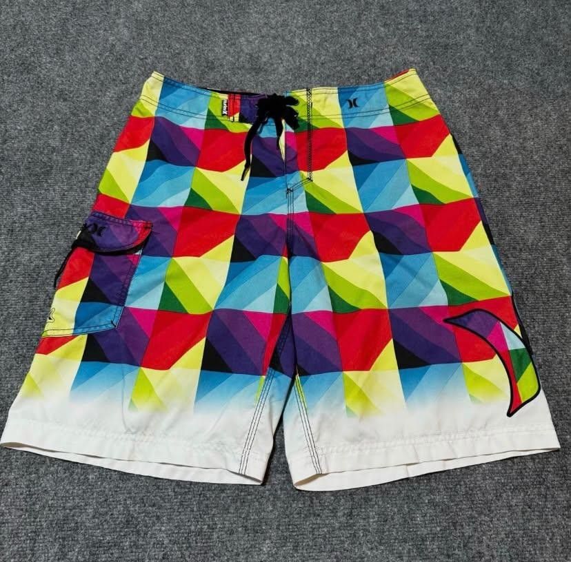 Hurley Multicolor Geometric Board Shorts (Category: Swim Trunks & Board Shorts) located in Manila. Submitted by vasteagle_347950 (Listing ID 1465565350, Image 2). Description: - Brand: Hurley Phantom - Design: Eye-catching colorful geometric gradient (blue, red, yellow, purple, green) with a white hem - Material: Lightweight, quick-drying fabric ideal for surfing and swimming - Features: Adjustable drawstring waist, velcro side cargo pocket with 
