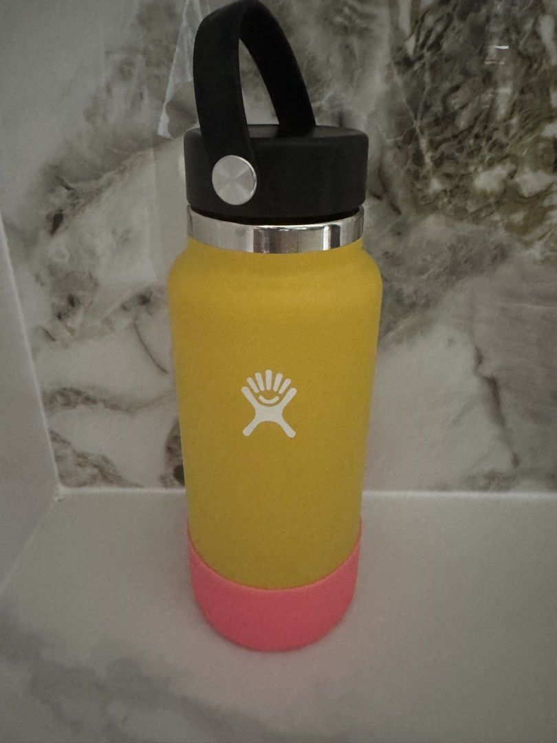Hydro Flask Insulated Water Bottle with Pink Boot (Category: Water Bottles & Tumblers) located in Manila. Submitted by decluterthings888 (Listing ID 1465397175, Image 2). Description: - Authentic Hydro Flask insulated water bottle in a vibrant yellow color - Features a secure black flex cap handle for easy carrying - Includes a pink silicone boot to protect against dings, dents, and scratches - Keeps your favorite drinks cold all day long - Perfe