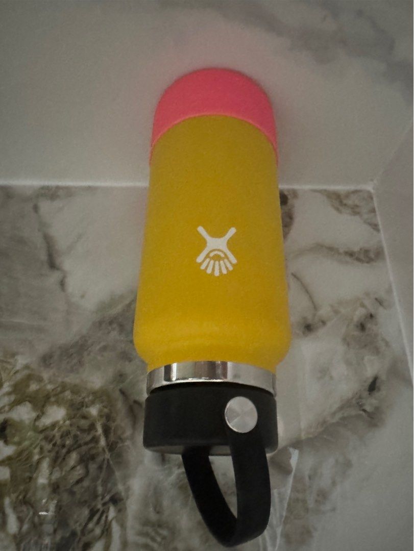 Hydro Flask Insulated Water Bottle with Pink Boot (Category: Water Bottles & Tumblers) located in Manila. Submitted by decluterthings888 (Listing ID 1465397175, Image 1). Description: - Authentic Hydro Flask insulated water bottle in a vibrant yellow color - Features a secure black flex cap handle for easy carrying - Includes a pink silicone boot to protect against dings, dents, and scratches - Keeps your favorite drinks cold all day long - Perfe