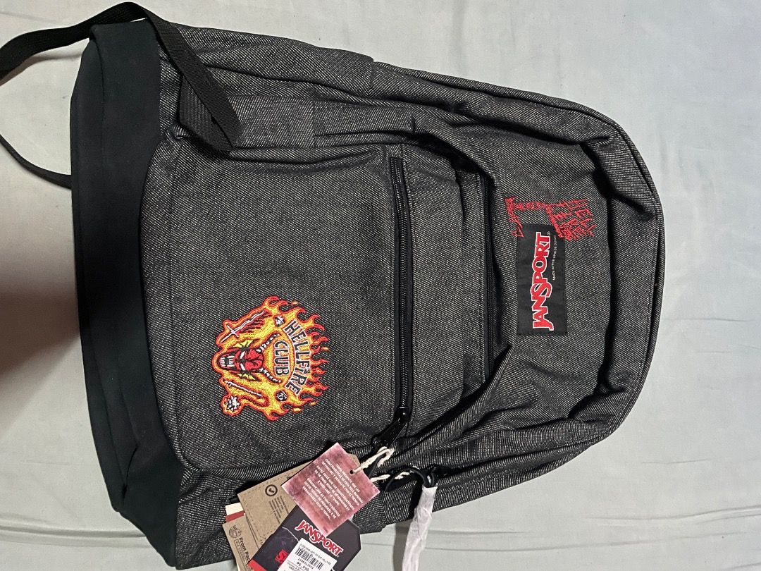 JanSport Stranger Things Hellfire Club Backpack (Category: Backpacks) located in Cebu City. Submitted by michaelbenida (Listing ID 1465406814, Image 1). Description: - Brand: JanSport x Stranger Things (Hellfire Club collection) - Condition: Brand new with original store tags, never used - Material/Design: Dark denim wash with iconic Hellfire Club front patch - Interior details: Red embroidery with JanSport logo tag - Perfect for daily use, schoo