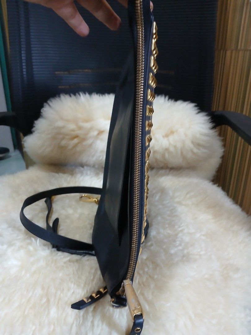 j.estina Black Leather Studded Shoulder Bag (Category: Shoulder Bags) located in Taguig. Submitted by demsclosetph (Listing ID 1465419918, Image 3). Description: - Brand: J.ESTINA - Material: Black leather with striking gold pyramid studs - Features: Vertical front zip pocket, signature crown logo hardware, and a versatile detachable shoulder strap - Interior: Fabric lining equipped with convenient slip and zipper pockets - Condition: Minor scuff