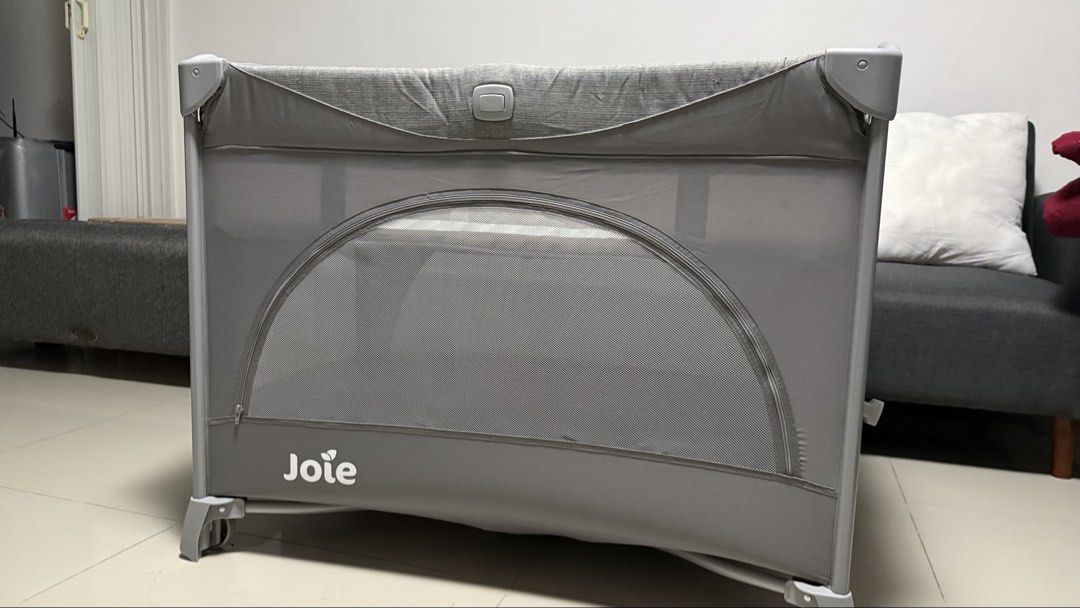 Joie Grey Portable Baby Cot Playpen (Category: Cots & Cribs) located in Paranaque City. Submitted by aneevesereth (Listing ID 1465540326, Image 1). Description: Joie portable baby cot in grey. Mesh sides for good airflow and visibility. Easy to fold and pack away into the included travel bag. Includes a padded foldable mattress base. Great for naps at home or travelling. Clean condition overall, setup and ready to use. No stain inside, no issue w