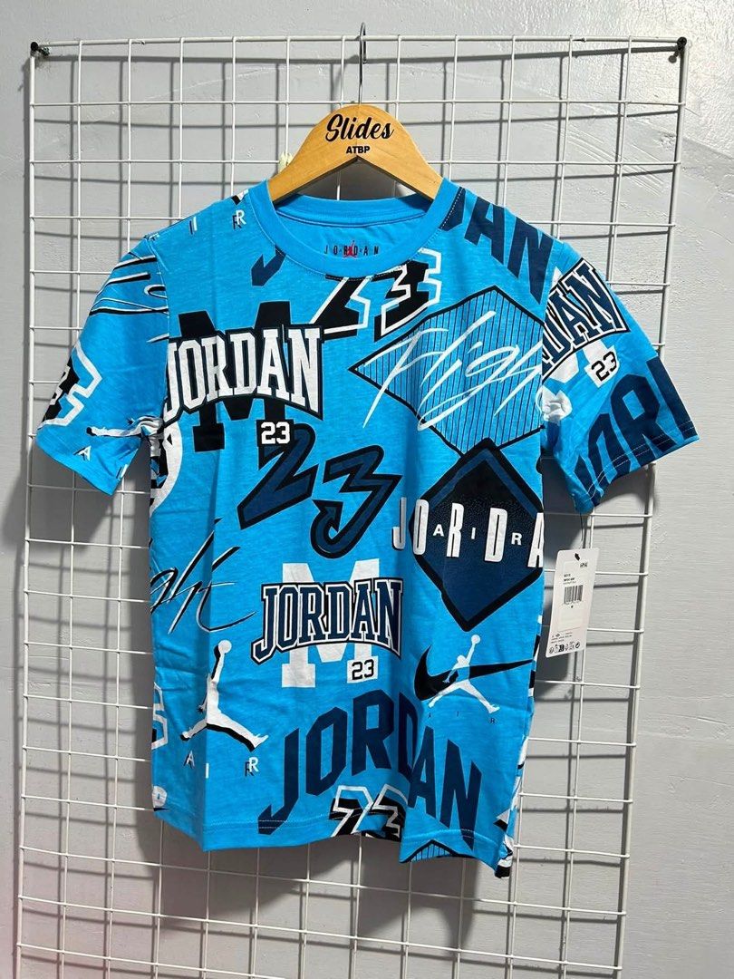 Jordan All-Over Print Blue T-Shirt (Category: Tshirts & Polo Shirts ) located in Agdangan. Submitted by chano11339 (Listing ID 1465559721, Image 1). Description: - Brand: Jordan - Color: Bright blue - Design: All-over print graphics, logos, and number 23 - Style: Short sleeves, crew neck - Condition: Brand new with original retail tag attached.