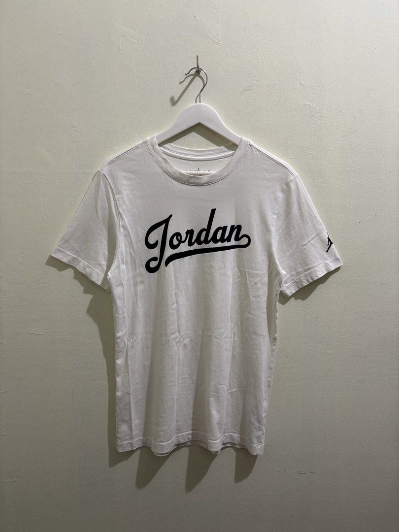 Jordan Script White T-Shirt (Category: Tshirts & Polo Shirts ) located in Daraga. Submitted by hannieldustin (Listing ID 1465477179, Image 1). Description: - Brand: Jordan - Style Code: FN5959-100 - Size: Small - Color: Clean White - Design: Large black script Jordan logo on chest, small Jumpman graphic on left sleeve - Neckline: Crew neck - Sleeves: Short sleeves - Condition: Excellent, clean fabric.