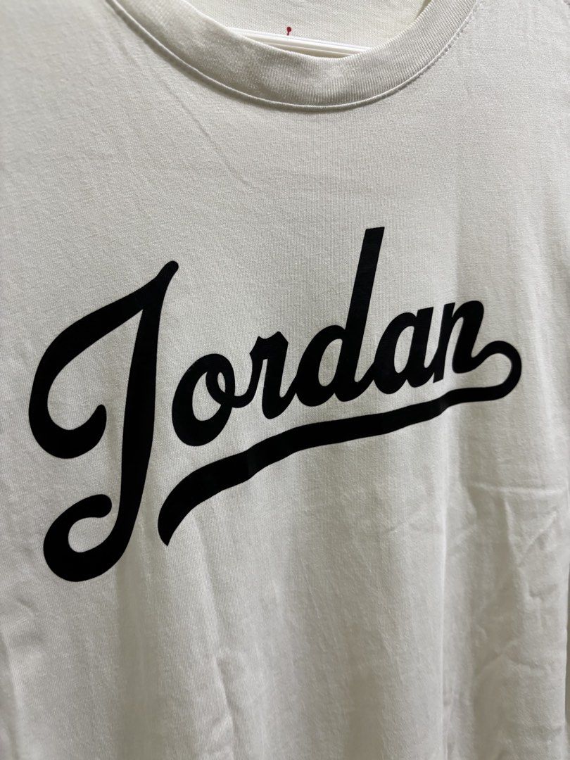 Jordan Script White T-Shirt (Category: Tshirts & Polo Shirts ) located in Daraga. Submitted by hannieldustin (Listing ID 1465477179, Image 2). Description: - Brand: Jordan - Style Code: FN5959-100 - Size: Small - Color: Clean White - Design: Large black script Jordan logo on chest, small Jumpman graphic on left sleeve - Neckline: Crew neck - Sleeves: Short sleeves - Condition: Excellent, clean fabric.