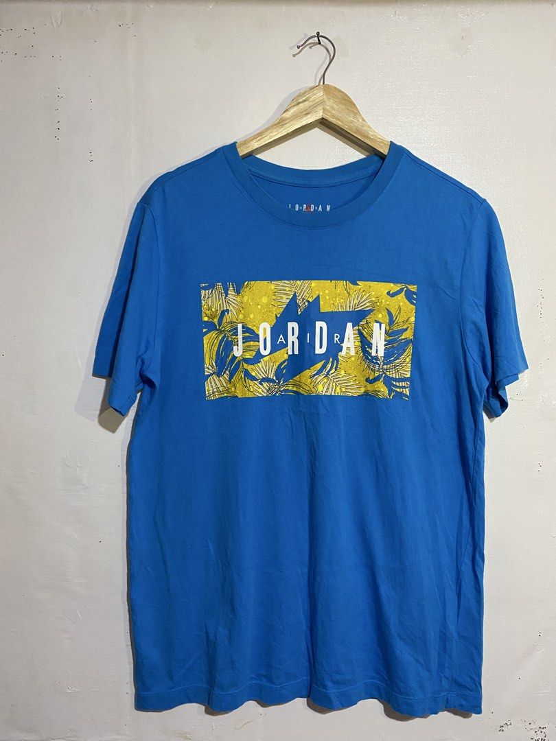 Jordan TSHIRT (Category: Tshirts & Polo Shirts ) located in Cebu City. Submitted by arsenyong (Listing ID 1465509530, Image 1). Description: - Brand: Jordan 20 by 27 Very good condition No issue Need wash only - Color: Bright blue with yellow and blue tropical leaf box graphic - Size: Large - Material: 100% cotton - Style Code: CQ2061-482 - Condition: Clean, vibrant graphics with no cracking.