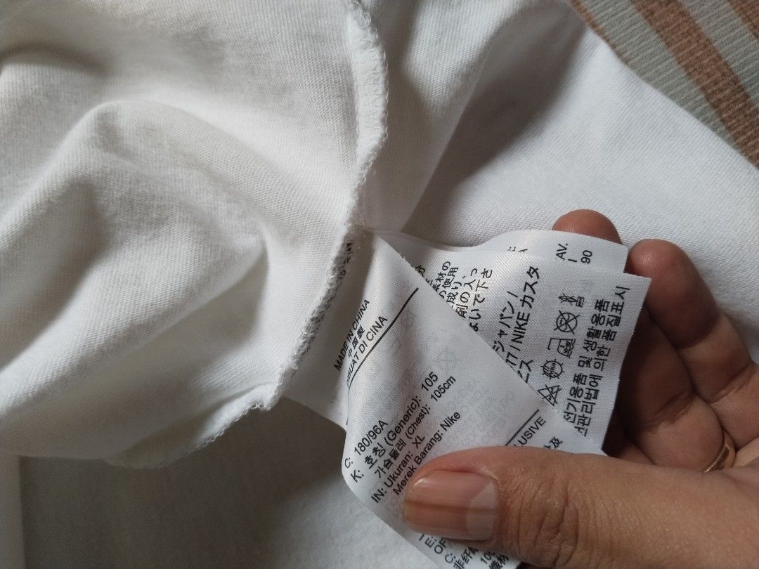 Jordan White T-Shirt Size XL (Category: Tshirts & Polo Shirts ) located in Manila. Submitted by polding25 (Listing ID 1465387175, Image 3). Description: - Brand: Jordan - Color: White with stylized black lettering - Size: XL (Approx. 21" width x 28" length) - Details: Jumpman logo on inner collar and sleeve, Made in China - Condition: Good overall, with a noticeable small pinkish stain near the bottom front hem.