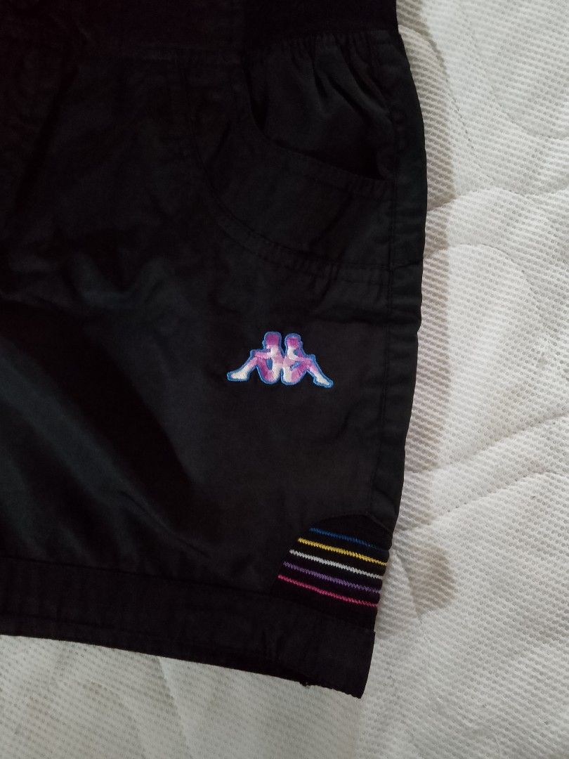 Kappa Black Shorts Size M (Category: Shorts) located in Aroroy. Submitted by itsyviii (Listing ID 1465526401, Image 3). Description: - Brand: Kappa - Color: Black with colorful stripe accents - Size: Medium (M) - Details: Embroidered front logo, light purple 'kappa' embroidery on back waistband, functional front pockets, and button waist closure - Condition: Great sporty piece, perfect for casual wear.