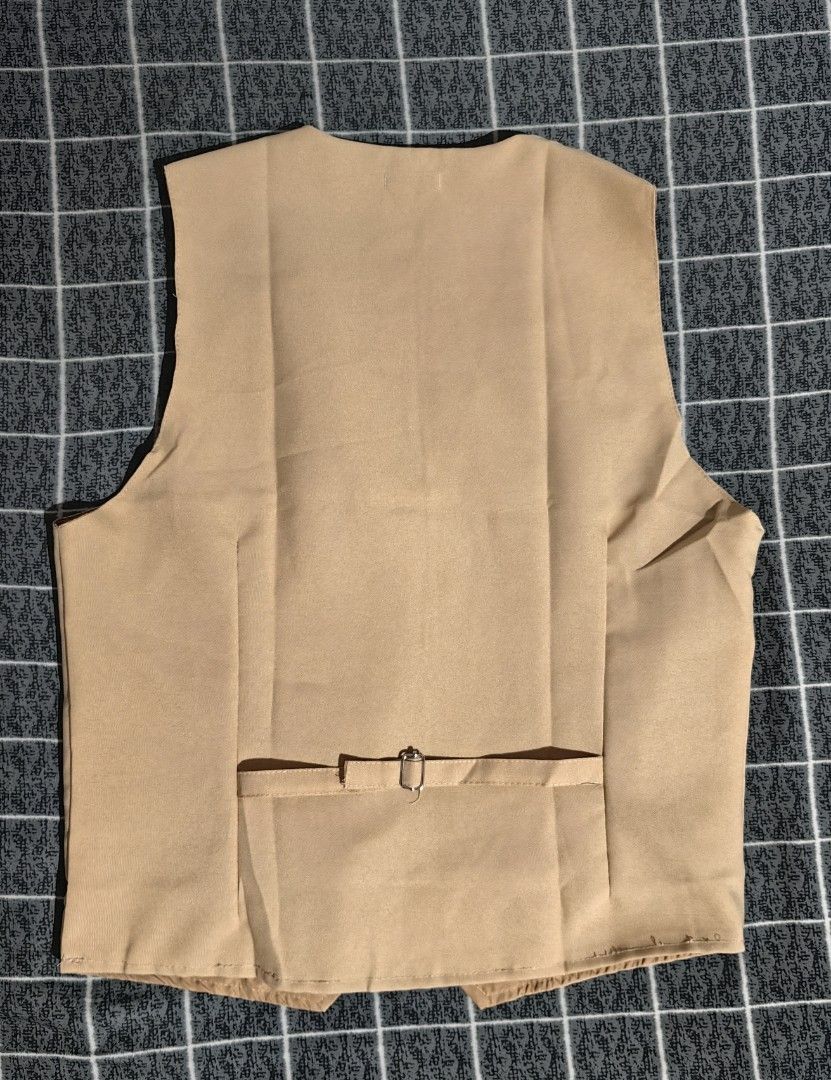 Khaki Vest with Black Bow Tie (Category: Vests) located in Pasay City. Submitted by roe.sell (Listing ID 1465471178, Image 3). Description: - Brand/Item: Lucky MJ khaki formal vest - Size: Tag visible inside near the collar - Includes: Matching black adjustable bow tie - Design: Two-button front closure with piped pocket details - Fit: Adjustable back strap with metal buckle for tailoring - Condition: Clean fabric throughout, ready to wear - Perf