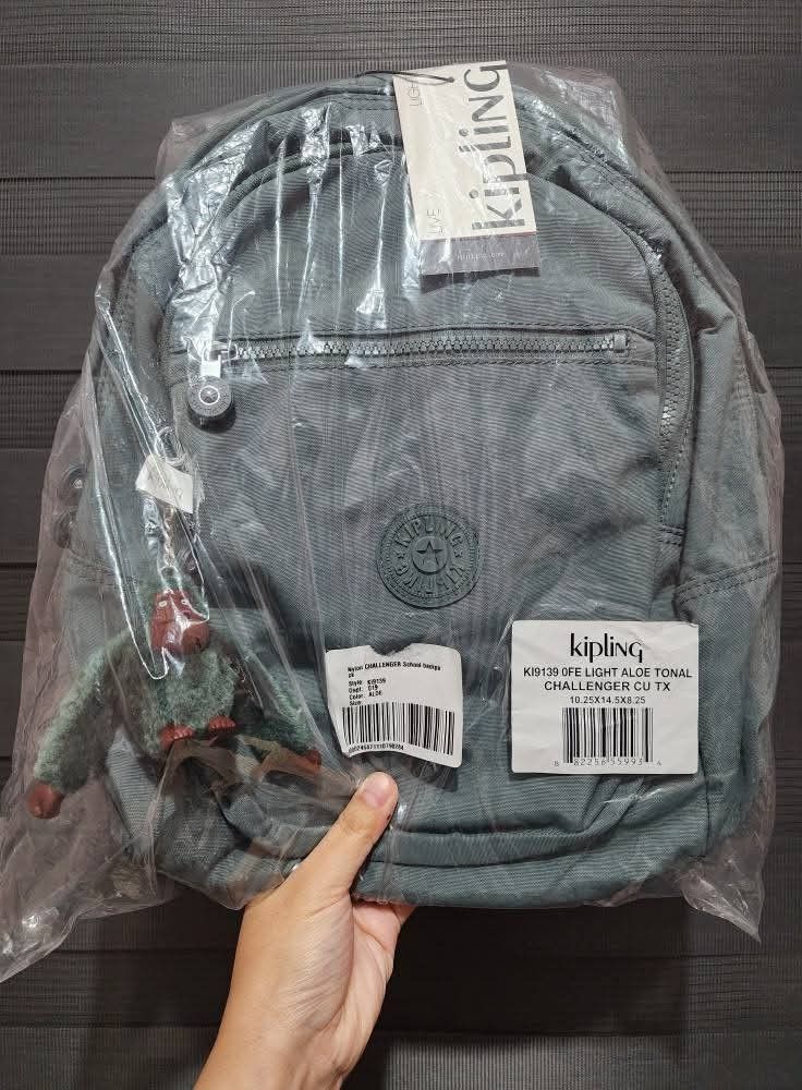 KIPLING CHALLENGER Backpack (Category: Backpacks) located in Quezon City. Submitted by senyoramaria2 (Listing ID 1465549576, Image 1). Description: KIPLING CHALLENGER Backpack Color: Light Aloe Volume: 16 Liters Dimensions: 10.25 x 14.5 x 8.25 inches Nylon Zipped main compartment with padded back panel and base. Front zipped pocket features an open pouch pocket, pen loop and key clasp. Additional external zipped pocket on front. Adjustable padded
