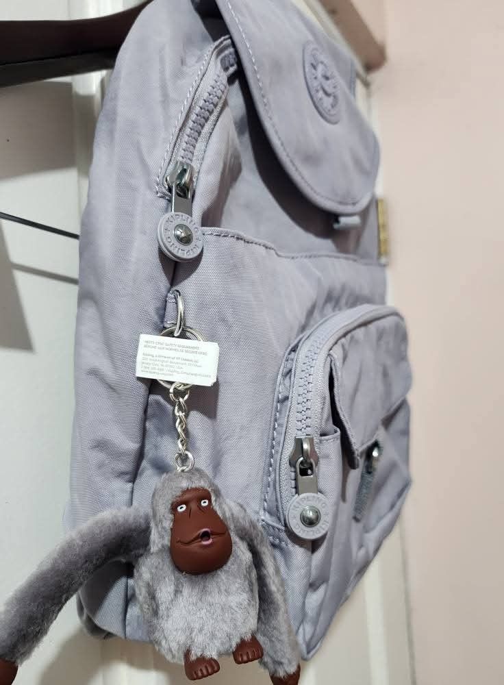 KIPLING QUEENIE Backpack (Category: Backpacks) located in Quezon City. Submitted by senyoramaria2 (Listing ID 1465549669, Image 3). Description: KIPLING QUEENIE Backpack Color: Dove Grey (Lilac) Volume: 12 Liters Dimensions: 10.25 x 13.5 x 7.5 inches Nylon Top handle Adjustable shoulder straps Front magnetic pocket Two front zip pockets Magnetic closure Zip around closure Monkey keychain Key clasp Note: Kasya tablet, folding umbrella and 8 notebo