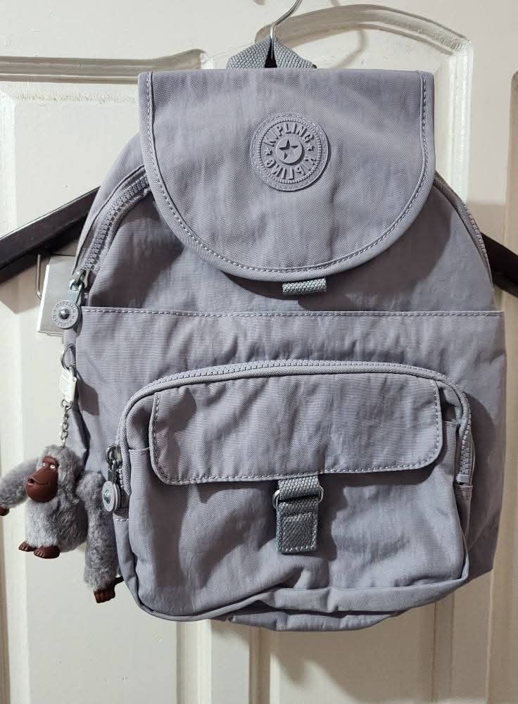 KIPLING QUEENIE Backpack (Category: Backpacks) located in Quezon City. Submitted by senyoramaria2 (Listing ID 1465549669, Image 2). Description: KIPLING QUEENIE Backpack Color: Dove Grey (Lilac) Volume: 12 Liters Dimensions: 10.25 x 13.5 x 7.5 inches Nylon Top handle Adjustable shoulder straps Front magnetic pocket Two front zip pockets Magnetic closure Zip around closure Monkey keychain Key clasp Note: Kasya tablet, folding umbrella and 8 notebo