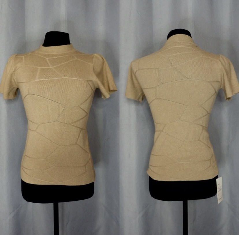 Knit Mock Neck Short Sleeve Top (Category: Blouses) located in Cainta. Submitted by vestito_bestida (Listing ID 1465475125, Image 3). Description: ⛔️ACTUAL PHOTO POSTED⛔️ 👉 Brandnew 👉 BKK 👉 Size: Free size 👉 Top length: 20" 👉 Full length 👉 Color: neutral beige 👉 Soft knit fabric with subtle geometric texture (front and back) 👉 Mock neckline, short sleeves, fitted 👉 Flatlay measured using medida 👉 Actual photo posted. 👉 No filter. Color