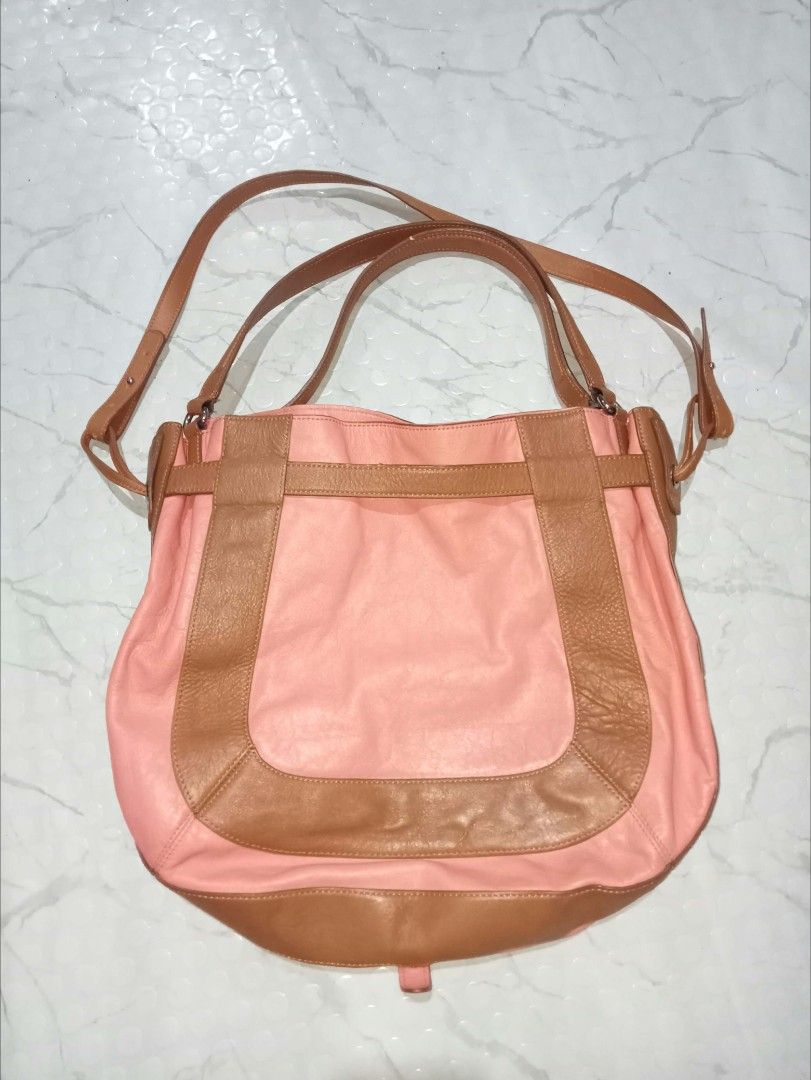 Kooba 2way Shoulder Bag (Category: Shoulder Bags) located in Bontoc. Submitted by tedanzthrift (Listing ID 1465562895, Image 2). Description: - Brand/Style: Kooba 2way - Carry options: Dual top handles and a long adjustable strap - Closure: Magnetic top snap closure with a front buckle detail.