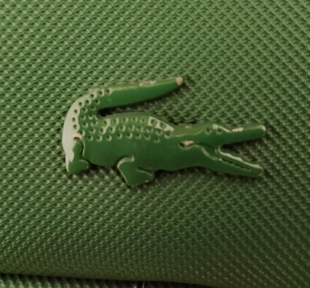 Lacoste Green Crossbody Bag (Category: Cross-body Bags) located in Manila. Submitted by i_canthriftyoubetter8 (Listing ID 1465421638, Image 3). Description: - Authentic green Lacoste crossbody bag in a clean, structured shape - Bold debossed LACOSTE lettering and signature crocodile logo on the front - Adjustable webbed strap with repeated Lacoste branding - Secure zip closure with a convenient front slip pocket - Great everyday size for daily es